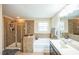 Bathroom with glass shower, bathtub, and tiled walls at 3005 Domaine Dr, Wake Forest, NC 27587