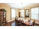 Dining room with a large wooden table set for a meal, a china cabinet, and natural light at 3005 Domaine Dr, Wake Forest, NC 27587