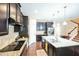 A kitchen with dark cabinets, granite countertops, a central island, and stainless steel appliances at 3005 Domaine Dr, Wake Forest, NC 27587