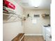 Functional laundry room featuring shelving, woven bench, and tile flooring at 3005 Domaine Dr, Wake Forest, NC 27587