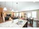 Open-concept living room featuring a kitchen island, living area, dining area, and plenty of natural light at 3005 Domaine Dr, Wake Forest, NC 27587