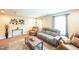 Neutral sitting area with recliner, couch, metal wall art, and windows with natural light at 3005 Domaine Dr, Wake Forest, NC 27587