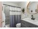 Bright bathroom showcases modern vanity and round mirror over sink at 311 Swift Ave Ave # 202, Durham, NC 27705