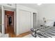 Bright bedroom showcases closet, with views of hallway and bed with patterned coverlet at 311 Swift Ave Ave # 202, Durham, NC 27705