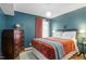 Comfortable bedroom featuring modern accents, hardwood floors, and a blue accent wall at 311 Swift Ave Ave # 202, Durham, NC 27705