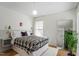 Bright bedroom with large mirror, big window, and patterned bedspread at 311 Swift Ave Ave # 202, Durham, NC 27705