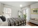 Comfortable bedroom featuring a window, stylish bedding, and modern accents at 311 Swift Ave Ave # 202, Durham, NC 27705