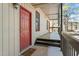 Charming covered entry porch with a bright red door and a welcoming doormat at 311 Swift Ave Ave # 202, Durham, NC 27705
