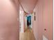 Hallway features stylish pink paint and leads to various rooms, showcasing the home's layout at 311 Swift Ave Ave # 202, Durham, NC 27705