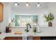 Modern kitchen with a view into the bright living room and large windows at 311 Swift Ave Ave # 202, Durham, NC 27705