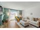 Bright living room with a cozy sofa, desk, and sliding glass doors leading to a balcony at 311 Swift Ave Ave # 202, Durham, NC 27705