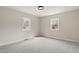Bedroom featuring neutral carpet, light-colored walls, and two windows with natural light at 312 W Union St, Hillsborough, NC 27278