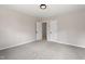Bedroom featuring neutral carpet, light-colored walls, and two doorways to hall and closet at 312 W Union St, Hillsborough, NC 27278