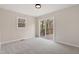 Bedroom with neutral carpet, light-colored walls, and sliding doors to a wooden deck at 312 W Union St, Hillsborough, NC 27278