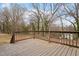 A wooden deck with stained railings overlooks the wooded backyard area at 312 W Union St, Hillsborough, NC 27278