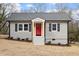 Charming renovated single-story home with a gray exterior, red front door, and simple landscaping at 312 W Union St, Hillsborough, NC 27278