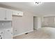 Bright kitchen features white cabinets, sleek hardware, light countertops, and wood-look flooring at 312 W Union St, Hillsborough, NC 27278