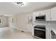 Open concept kitchen-living room featuring modern appliances and neutral tones at 312 W Union St, Hillsborough, NC 27278