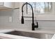 Modern kitchen faucet and sink with light backsplash against a window at 312 W Union St, Hillsborough, NC 27278