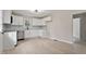 Well-lit kitchen featuring new stainless appliances, white cabinets, and wood-look flooring at 312 W Union St, Hillsborough, NC 27278