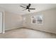 Spacious living room with a ceiling fan, a view of the exterior, and light wood flooring at 312 W Union St, Hillsborough, NC 27278