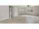 Living room featuring wood-look floors, modern ceiling fan, and access to front door at 312 W Union St, Hillsborough, NC 27278