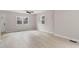 Living room with light-colored walls, wood-look flooring, ceiling fan, and windows at 312 W Union St, Hillsborough, NC 27278