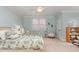 Bright bedroom with twin beds, ceiling fan, and serene pastel walls at 3320 Tree Farm Rd, Hillsborough, NC 27278