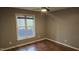 This bedroom offers natural light, a ceiling fan, and hardwood flooring at 3916 Allen W St, Raleigh, NC 27603