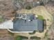 Aerial view showing the home's layout, patio, fire pit, mature trees and beautiful backyard at 400 Edinburgh Dr, Cary, NC 27511