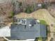 Aerial view showcasing the home's layout, patio, fire pit, mature trees and beautiful backyard at 400 Edinburgh Dr, Cary, NC 27511