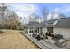 Spacious backyard featuring a sunroom, stone patio and lush greenery at 400 Edinburgh Dr, Cary, NC 27511