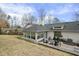 Spacious backyard featuring a sunroom, stone patio and lush greenery at 400 Edinburgh Dr, Cary, NC 27511