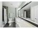 Well-lit bathroom with a large mirror, modern fixtures, and elegant tile work in shower at 400 Edinburgh Dr, Cary, NC 27511
