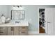 Bathroom featuring neutral vanity, contemporary mirror, and view of a closet at 400 Edinburgh Dr, Cary, NC 27511