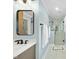 Bathroom featuring neutral vanity, contemporary mirror and walk in shower at 400 Edinburgh Dr, Cary, NC 27511