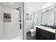 Updated bathroom with white tiled shower, neutral vanity, mirror, and black fixtures at 400 Edinburgh Dr, Cary, NC 27511