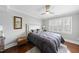 Bedroom with hardwood floors, a ceiling fan, neutral walls, and a comfortable queen-sized bed at 400 Edinburgh Dr, Cary, NC 27511