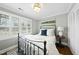 Comfortable bedroom featuring hardwood floors, neutral walls, and an abundance of natural light at 400 Edinburgh Dr, Cary, NC 27511