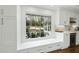 Cozy kitchen nook with a window seat, built-in storage, and a view of the outdoor patio area at 400 Edinburgh Dr, Cary, NC 27511
