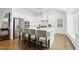 A bright kitchen features an island with seating, stainless steel appliances, and sleek white cabinetry at 400 Edinburgh Dr, Cary, NC 27511