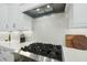 Modern kitchen with stainless steel appliances, white cabinets, and a stylish herringbone backsplash at 400 Edinburgh Dr, Cary, NC 27511