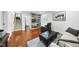 Cozy living room with hardwood floors, a grey sofa, and recliner, with built in shelves at 400 Edinburgh Dr, Cary, NC 27511