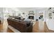 Open living room and kitchen area featuring modern appliances, ample seating, and a cozy fireplace at 400 Edinburgh Dr, Cary, NC 27511