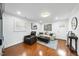 Living room with hardwood floors, recliner, light grey sofa and ottoman, and built in shelves at 400 Edinburgh Dr, Cary, NC 27511