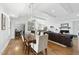 Open-concept living and dining area with hardwood floors and a fireplace. Kitchen in background at 400 Edinburgh Dr, Cary, NC 27511