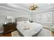 Main bedroom features a tray ceiling, hardwood floors, and plantation shutters on the window at 400 Edinburgh Dr, Cary, NC 27511