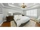 Main bedroom features a tray ceiling, neutral colored walls, and a decorative light fixture at 400 Edinburgh Dr, Cary, NC 27511