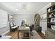 Home office with hardwood floors, natural light, desk, chair, and built-in shelving at 400 Edinburgh Dr, Cary, NC 27511