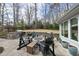 Stunning outdoor patio featuring a fire pit, comfortable seating, grill and lush backyard; ideal for entertaining at 400 Edinburgh Dr, Cary, NC 27511